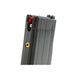 Gray magazine with a red button on a white background