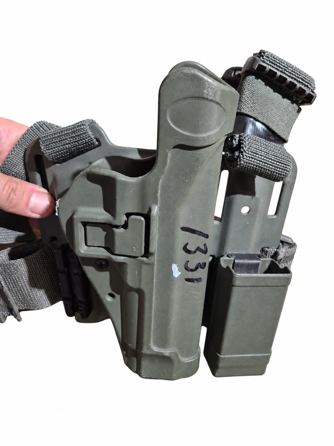 Hand-held view of the holster and magazine carrier showing inventory number 1331 and white surface marks.