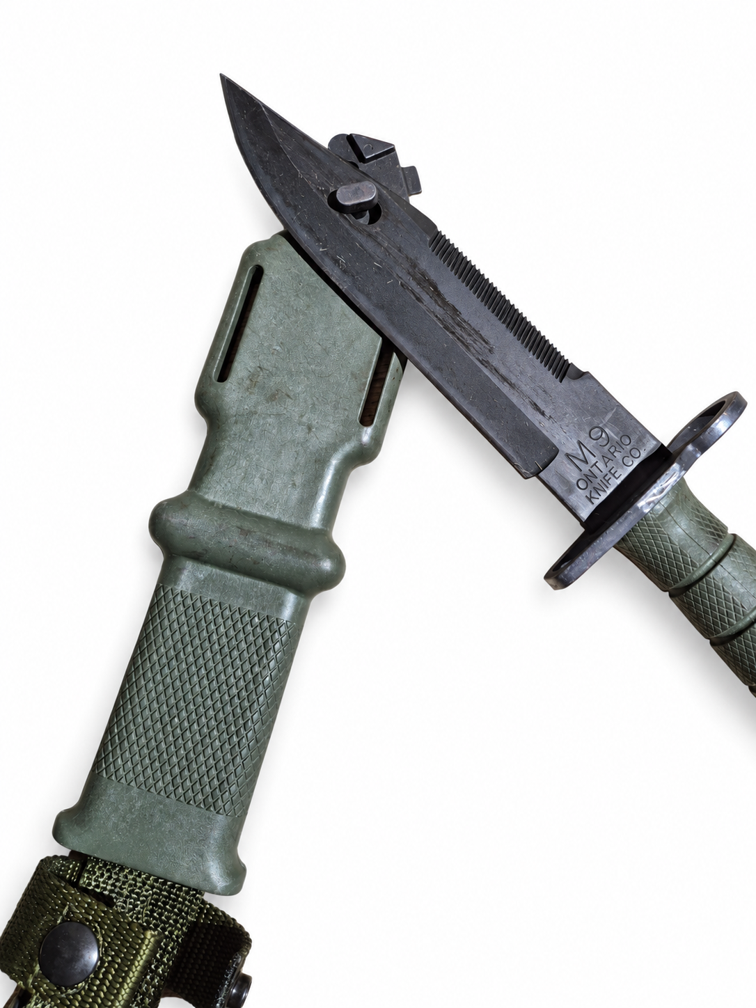 Ontario M9 blade and metal scabbard fitting shown in a detailed view.