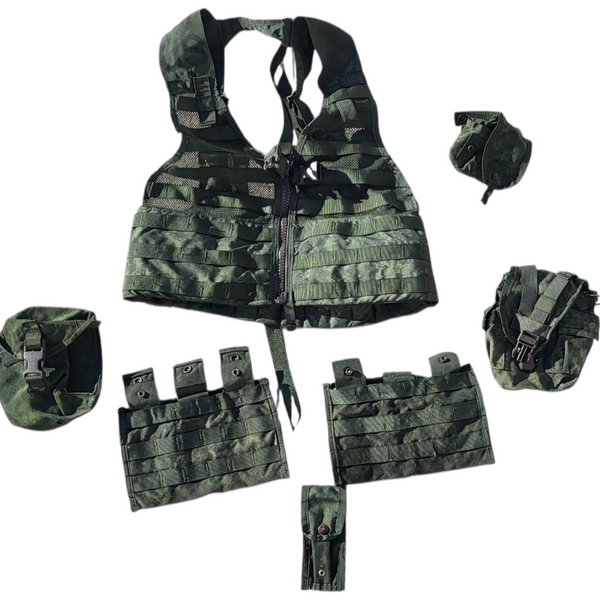 Camouflage tactical vest with various pouches and equipment on a white background