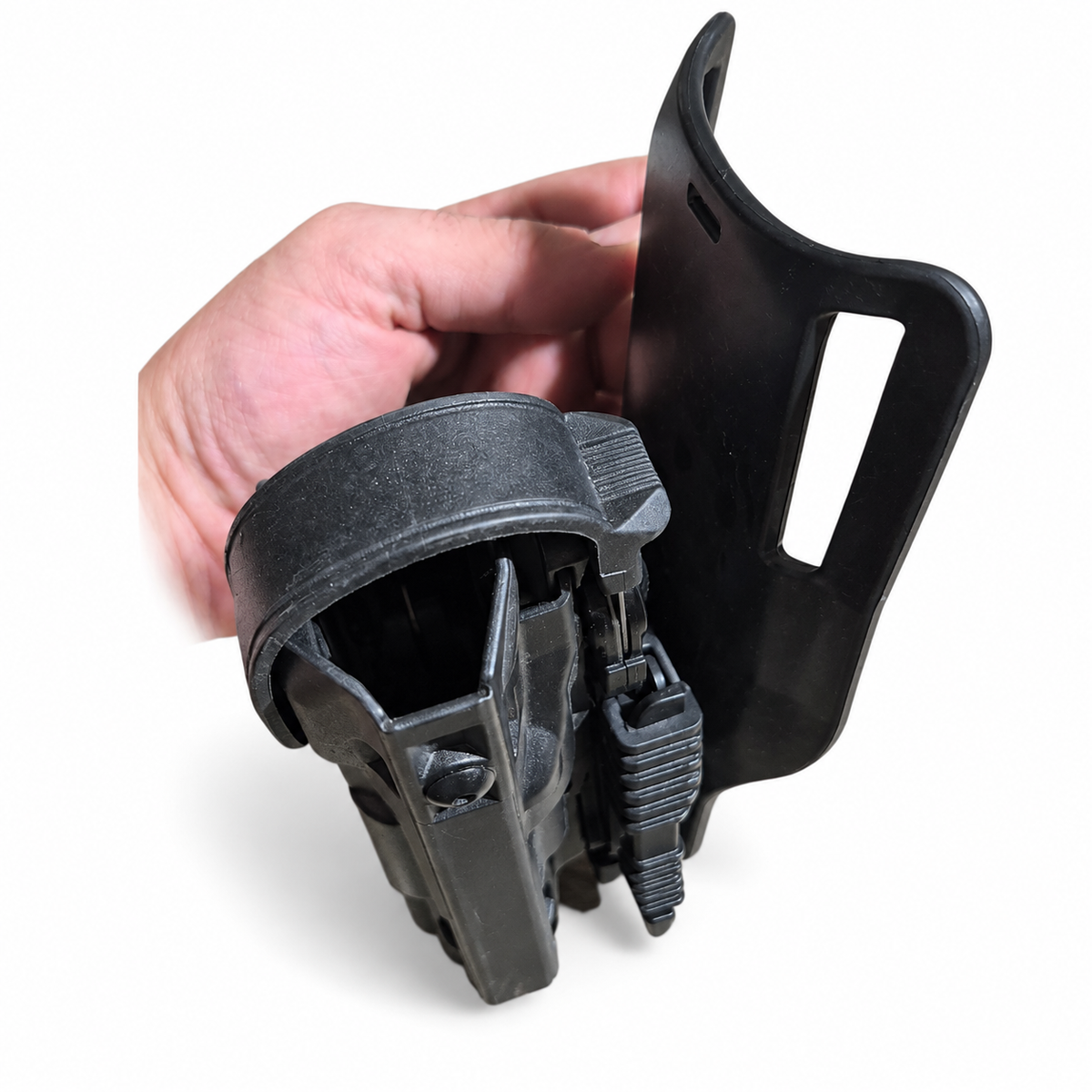 Upper angled view of empty Safariland holster showing retention hood and mounting hardware